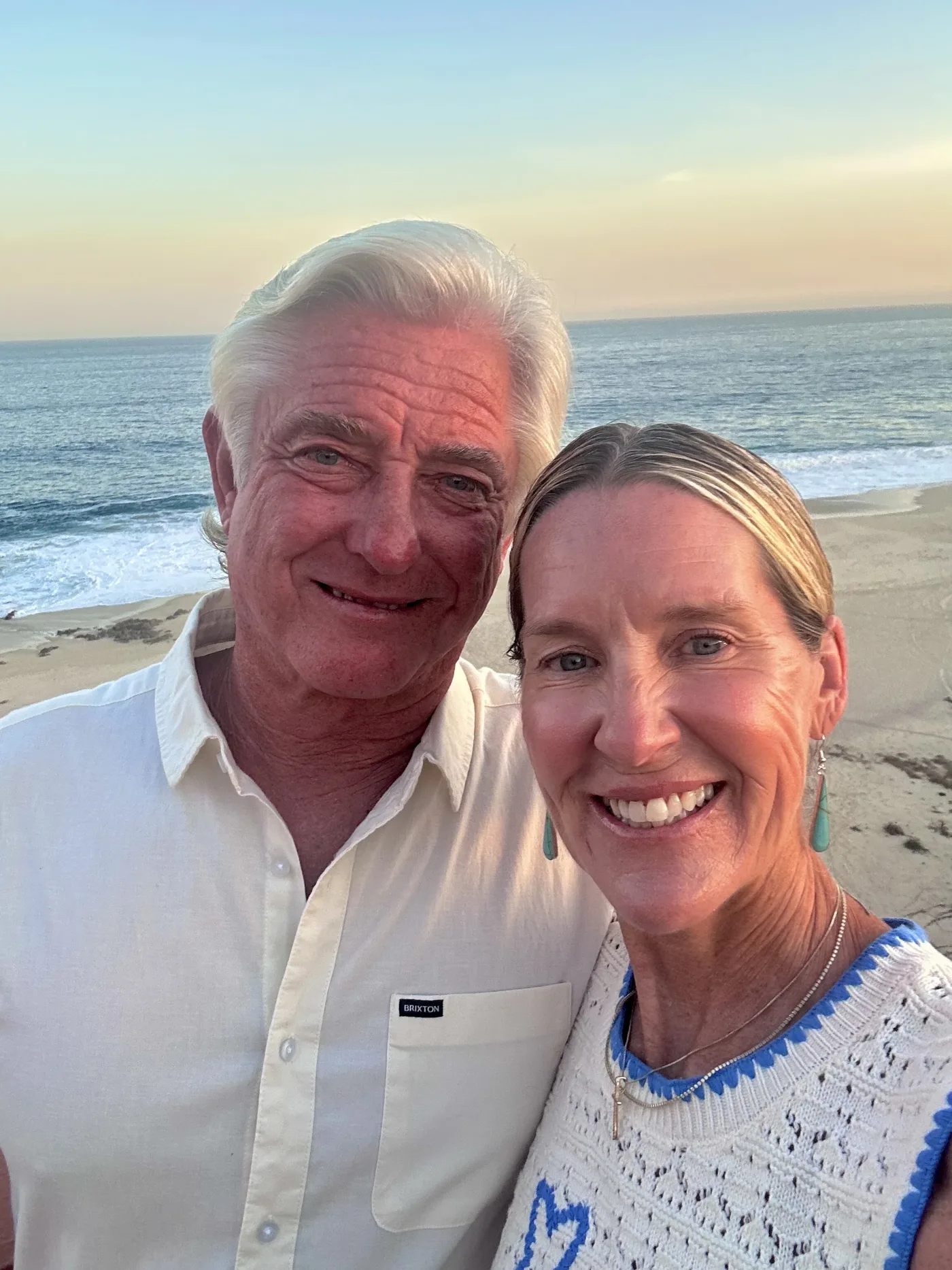 Mark and Tracey, founders of Urban Jungle, at the beach at sunset